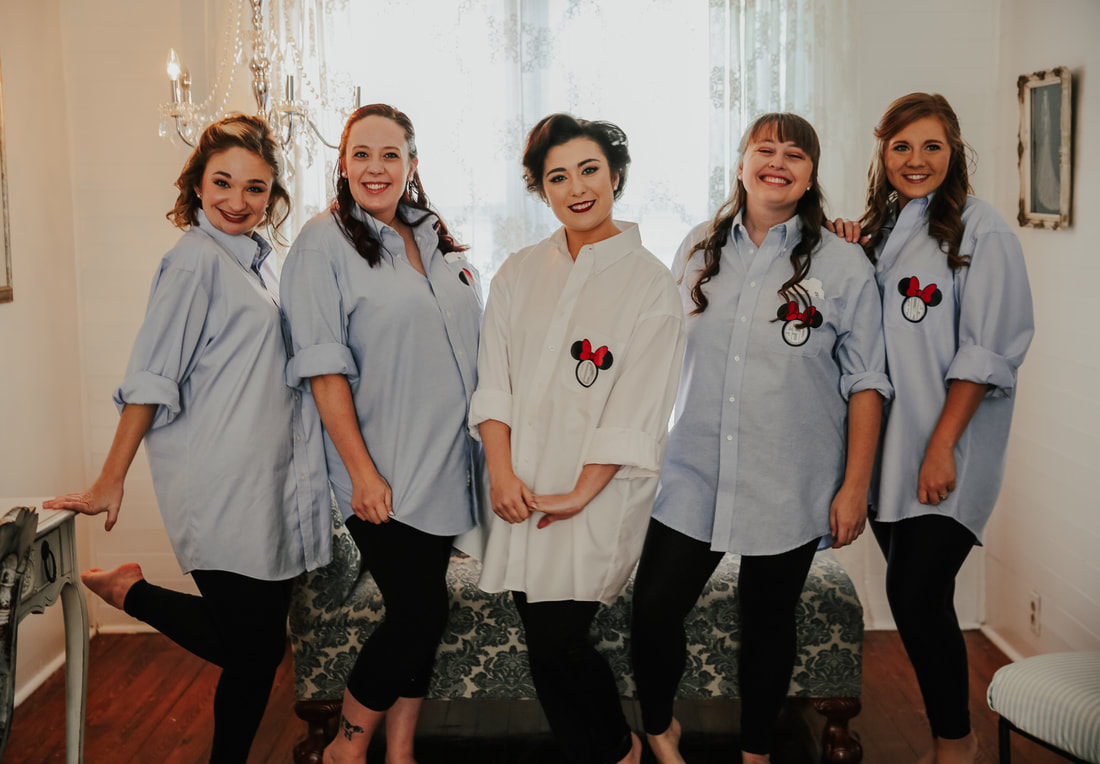 bride and bridesmaids in button-up shirts with minnie mouse logo