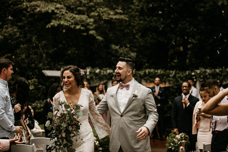 bride and groom laughing during outdoor October recessional
