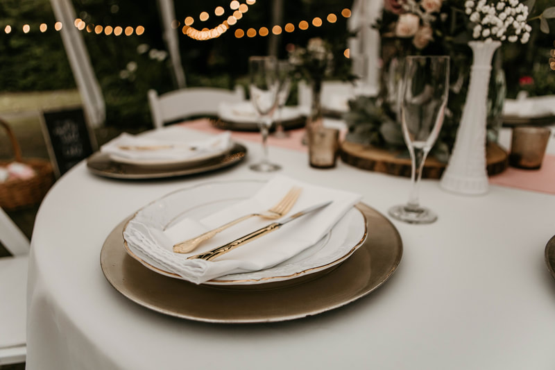 modern table setting with gold charger and engraved china