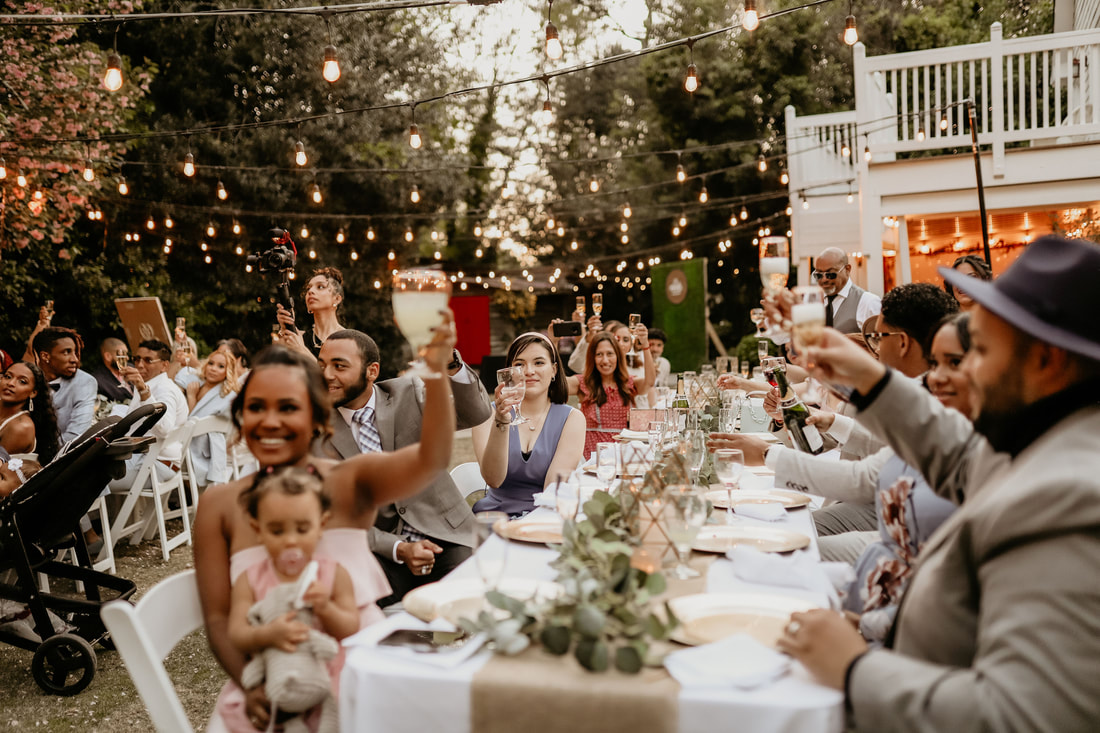 Guests raising toasts at intimate garden reception