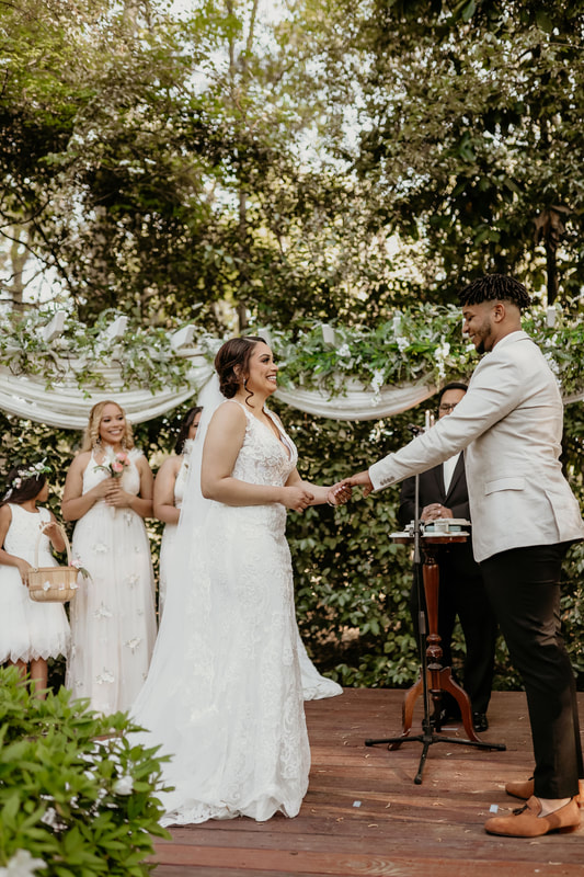 hispanic bride and groom at garden altar