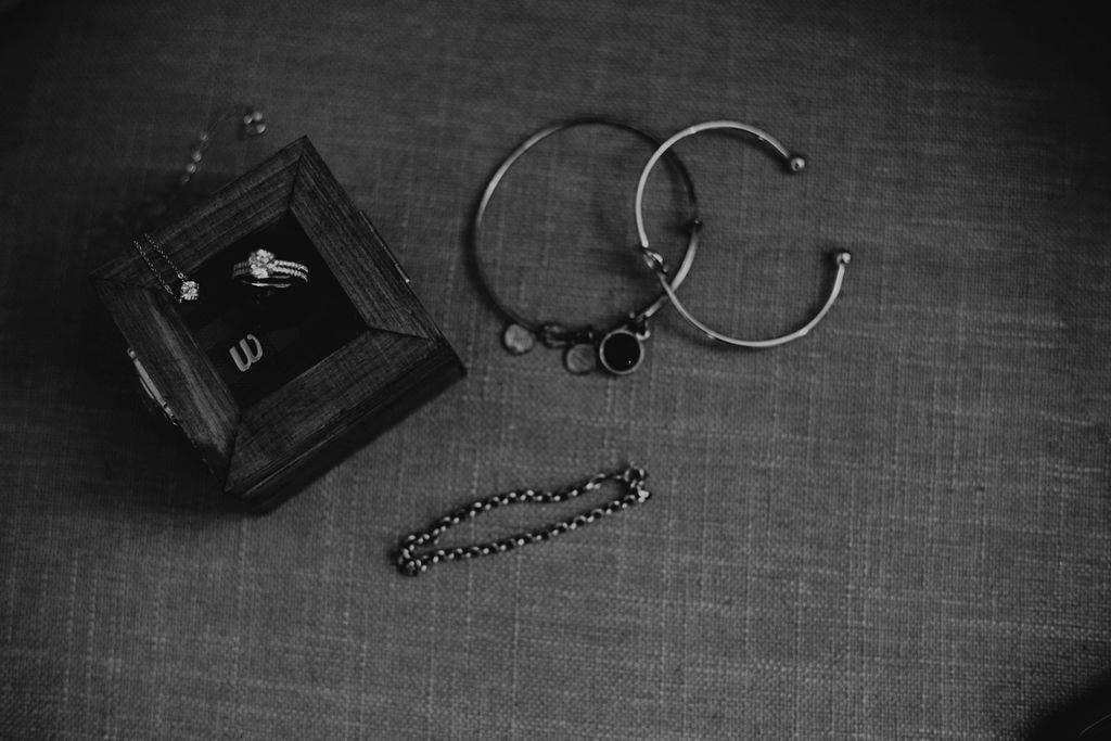 black and white photo of jewelry on couch