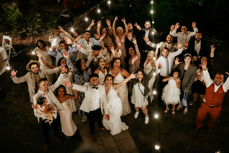 Bride and groom with all their guests posing for an aerial shot of their reception.