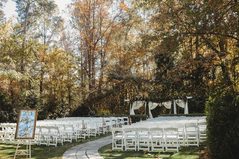outdoor garden ceremony with gold mirror sign