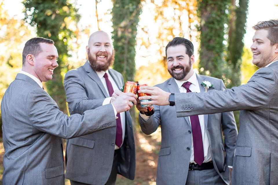 Groom and groomsmen celebrating with beer