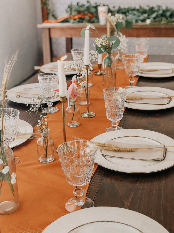 boho tablescape with burnt orange runner and neutral place settings