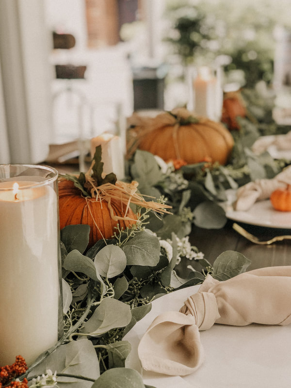 Husk pumpkins mixed with greenery for fall centerpieces