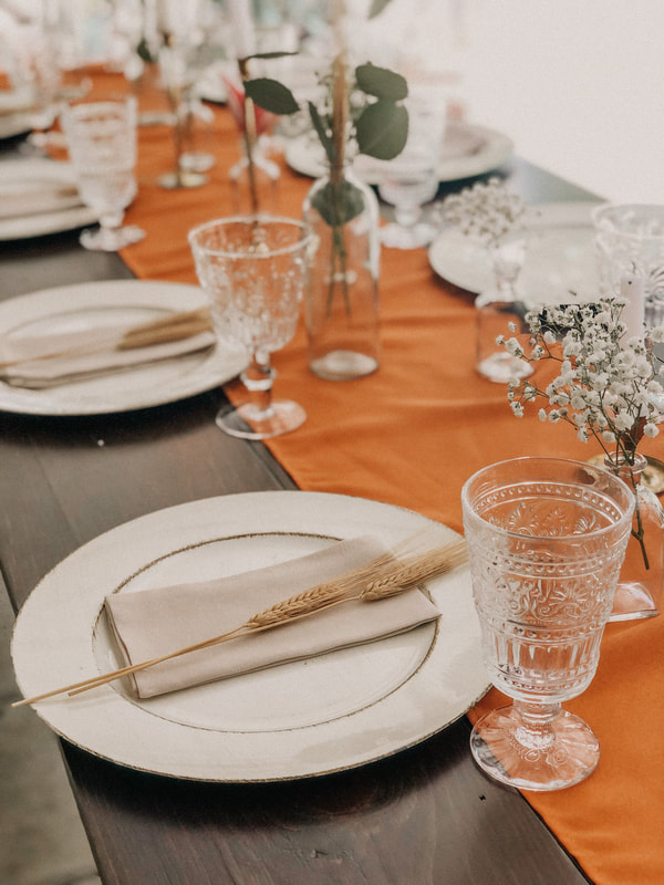 boho farm table decor with burnt orange runner and earth-toned place settings