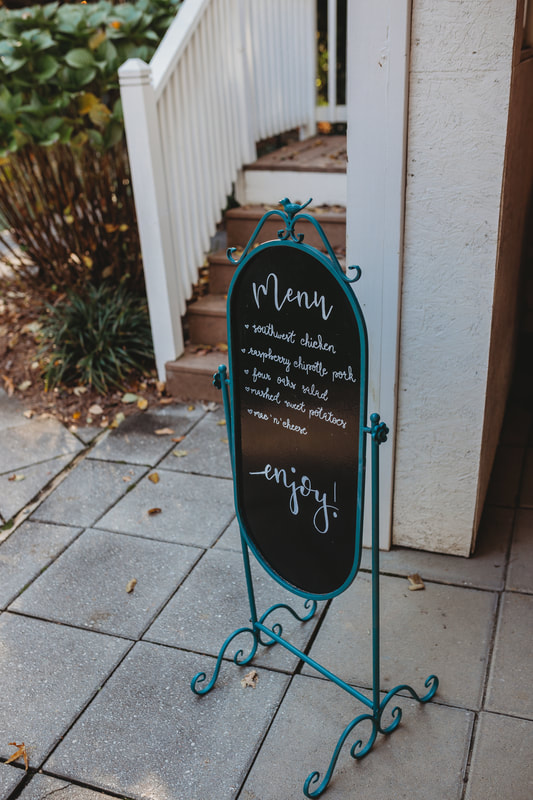fall wedding menu on blue chalkboard sign