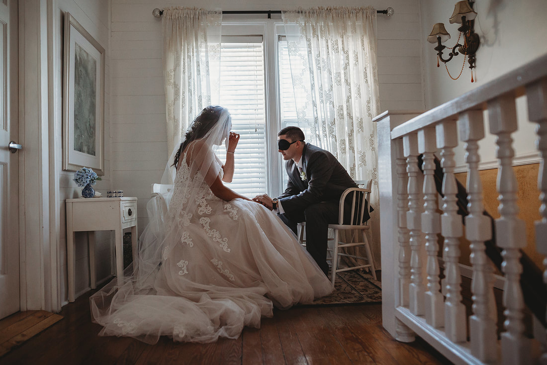 groom blindfolded for first look in farmhouse