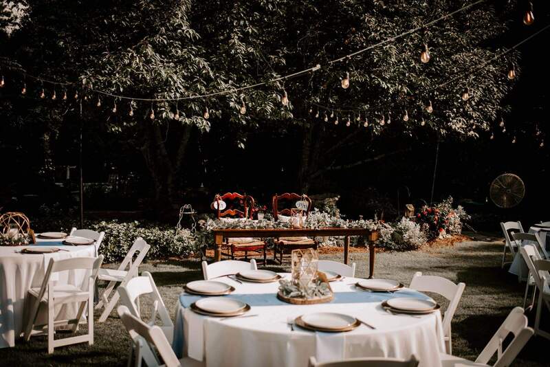 summer wedding with blue, gold and greenery table decorations
