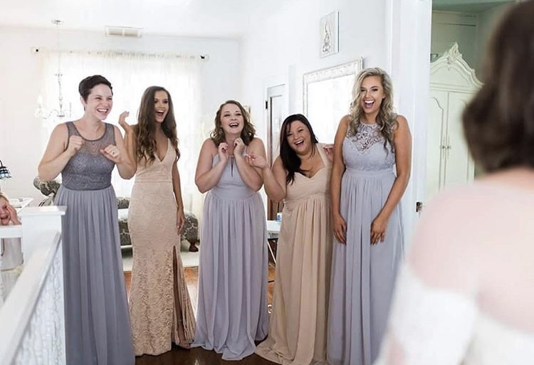 bride's first look with bridesmaids in getting ready space