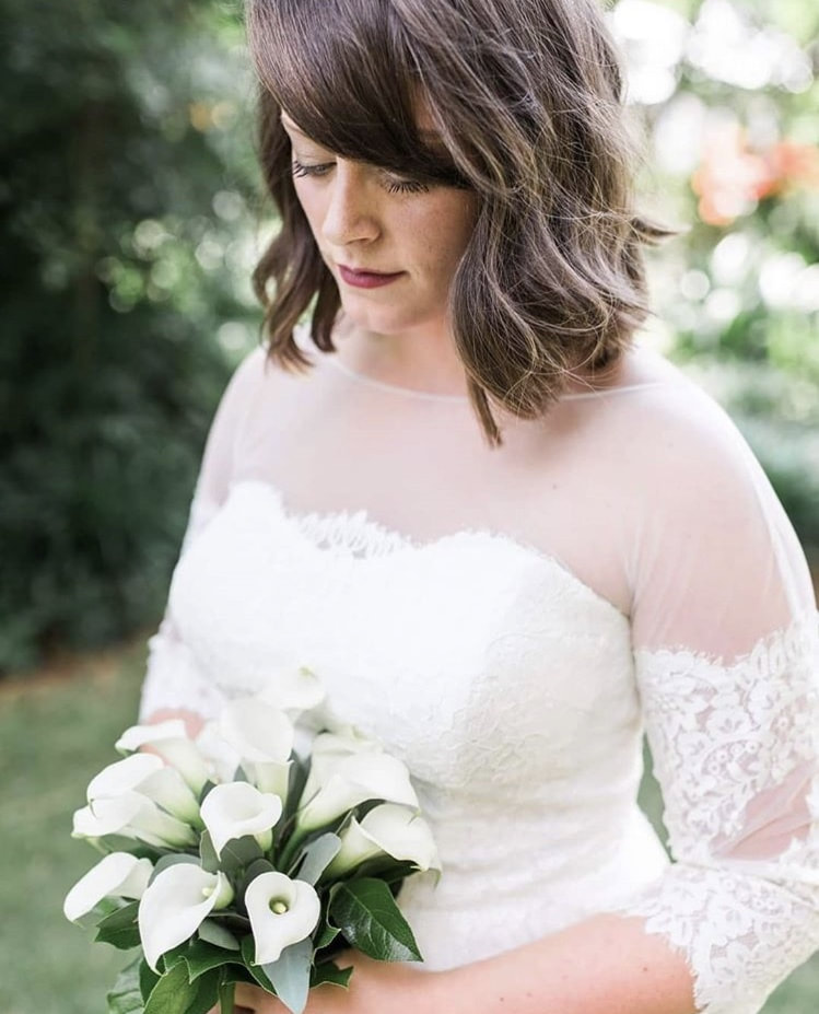 bride in white dress with sweetheart neckline and sheer top