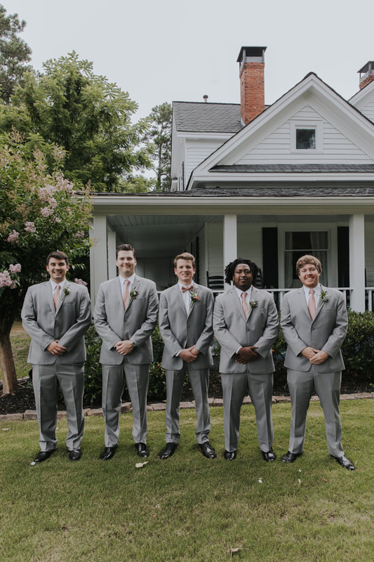 groomsmen and groom in gray suits