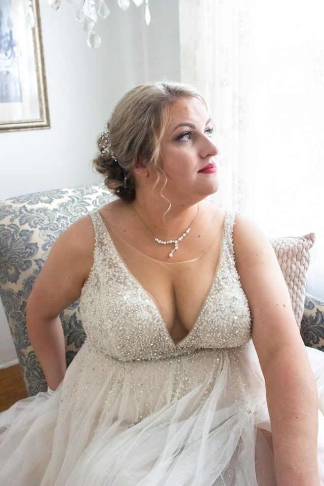 bride in sparkly deep-v dress in bridal suite