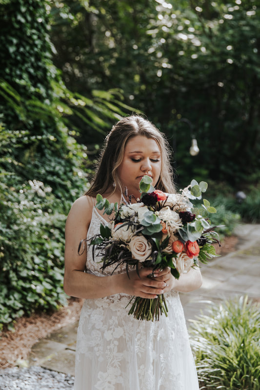 bride holding boho bouquet with eucalyptus