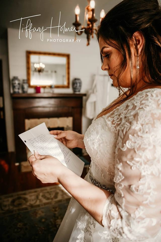 Bride reading handwritten letter from groom