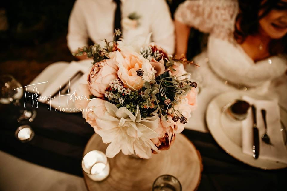 bride's bouquet as sweetheart table centerpiece