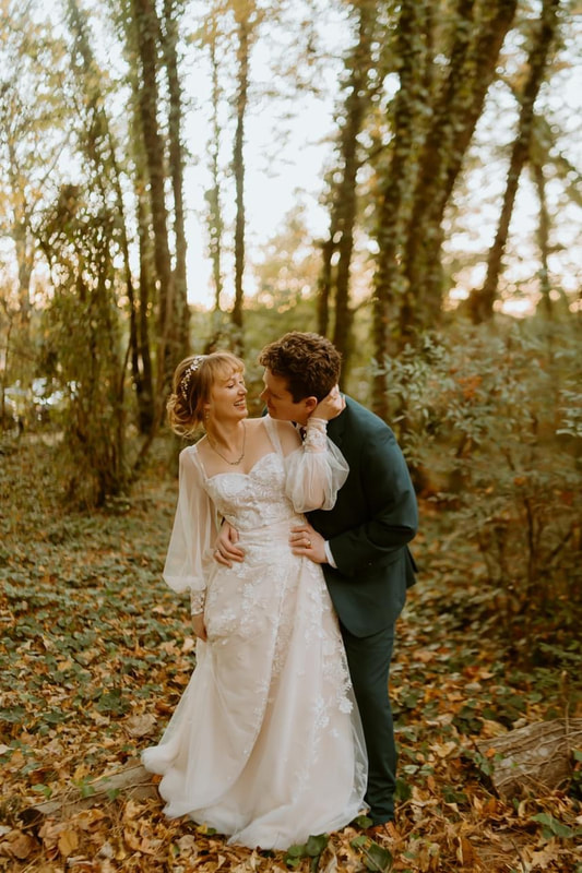 november vintage inspired wedding couple among ivy-covered trees