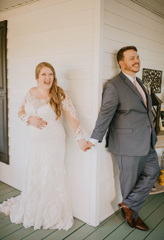 bride and groom doing first touch around farmhouse porch