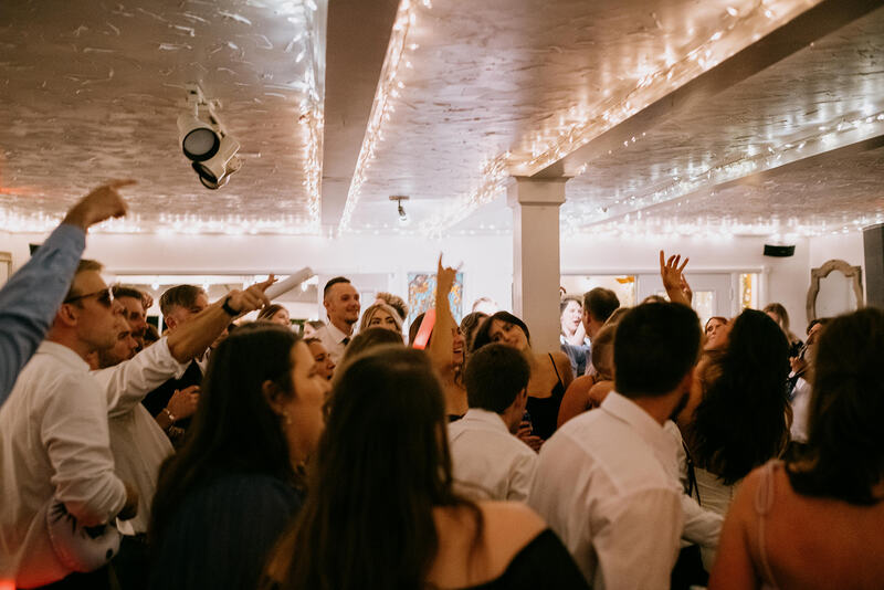 guests dancing in white farmhouse ball room