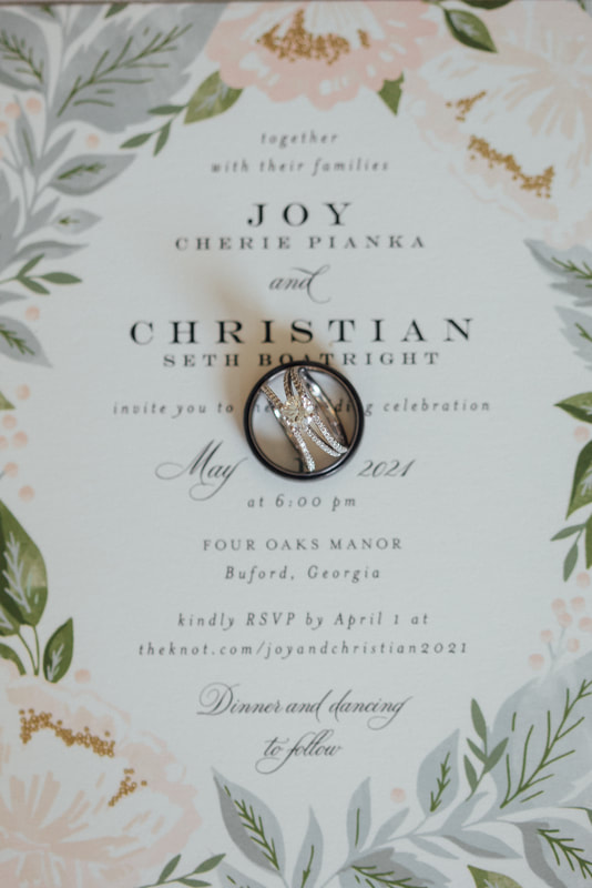 Elegant tan wedding invitation with floral decorations and RSVP instructions.
