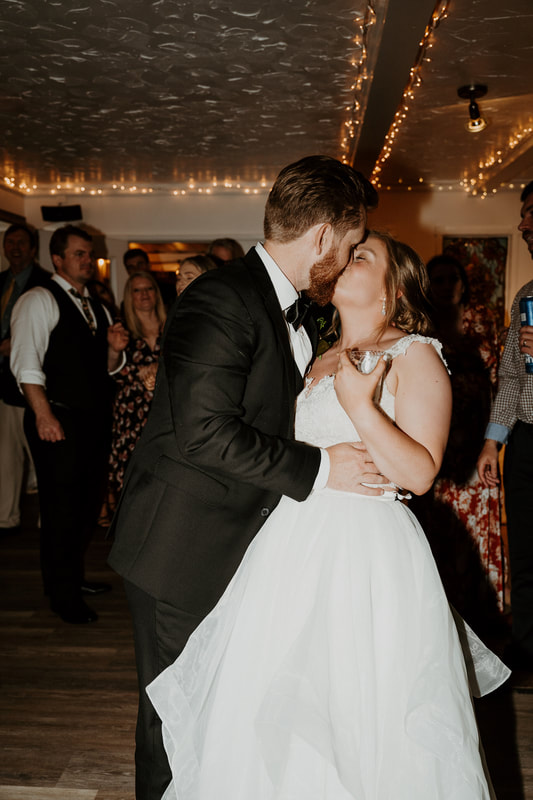 bride and groom kissing during reception dancing