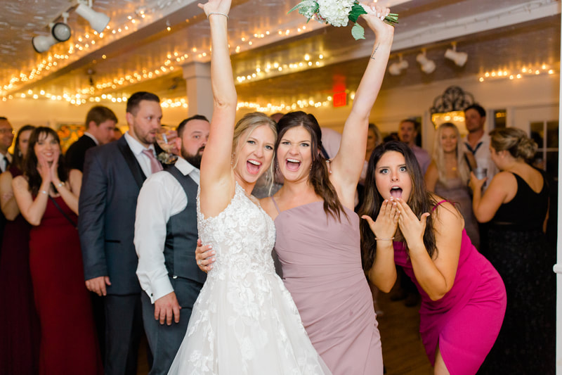bride with bridesmaid after bouquet toss