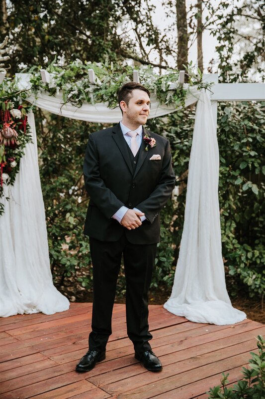 groom waiting at outdoor altar