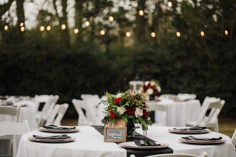moody black and burgundy reception tables