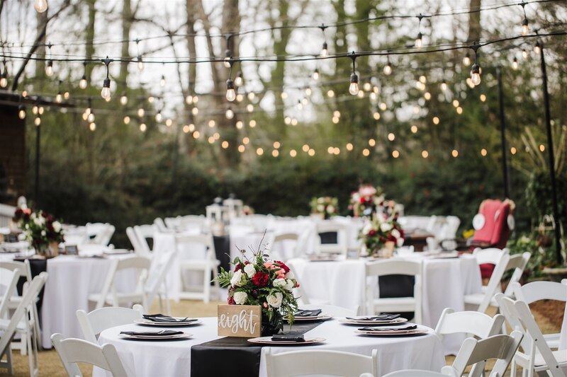 moody black, blush, and burgundy outdoor reception tables