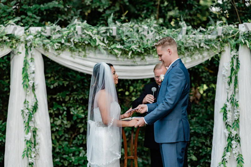 couple giving each other vows during july ceremony