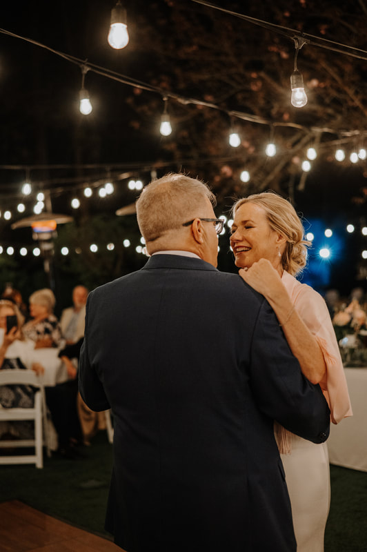 bride and groom dancing at outdoor wedding reception