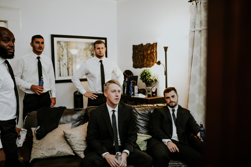 groomsmen sitting on couch in groom's room