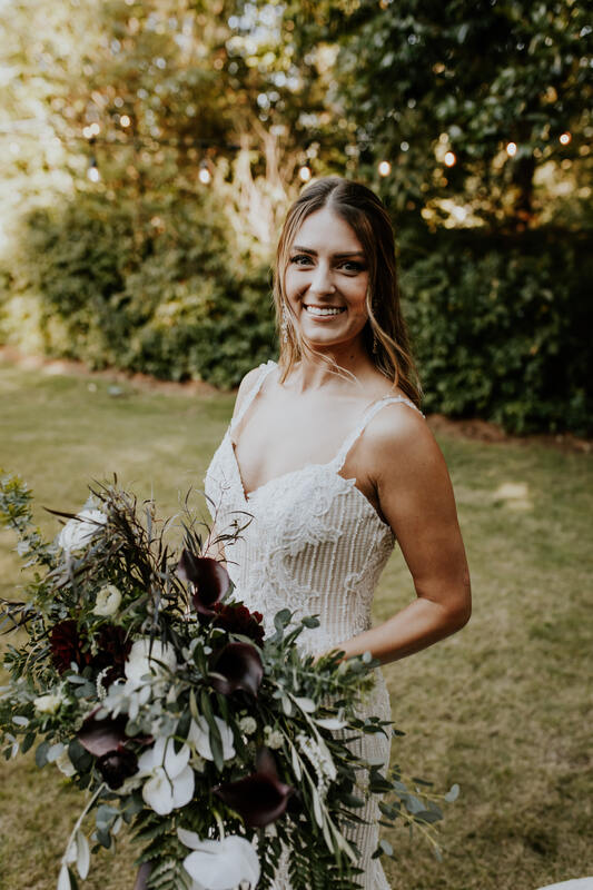 bride in boho dress with organic bouquet