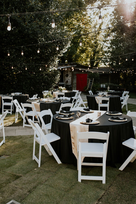 outdoor reception with black and champagne tables