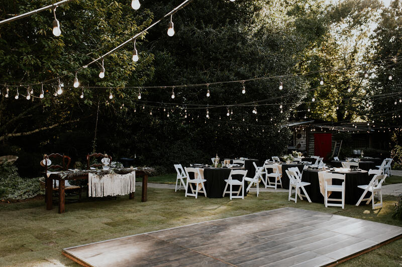head table, guest tables, and outdoor dance floor at outdoor reception 