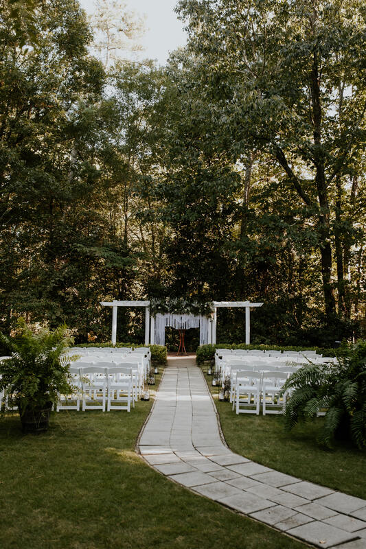 fall boho wedding ceremony area with ferns and macramé altar