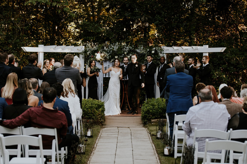 guests clapping for bride and groom at outdoor ceremony