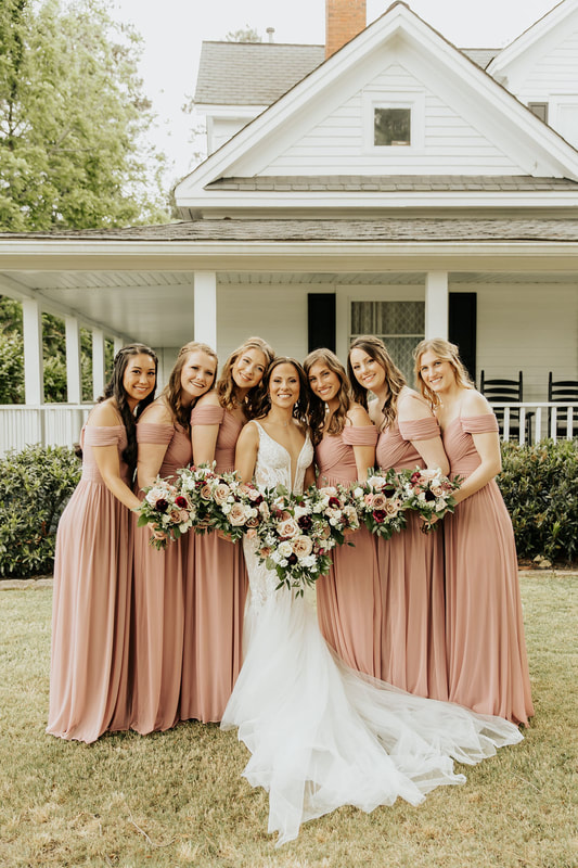 bride with bridesmaids in dusty rose dresses
