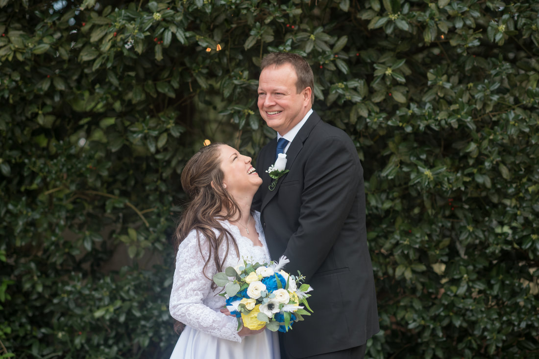 older newlyweds laughing in Four Oaks' gardens