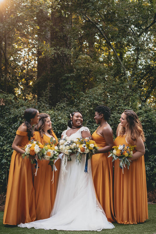 mustard bridesmaids posing with bride