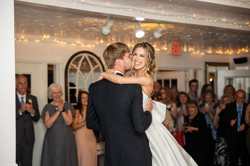groom kissing bride's cheek during first dance