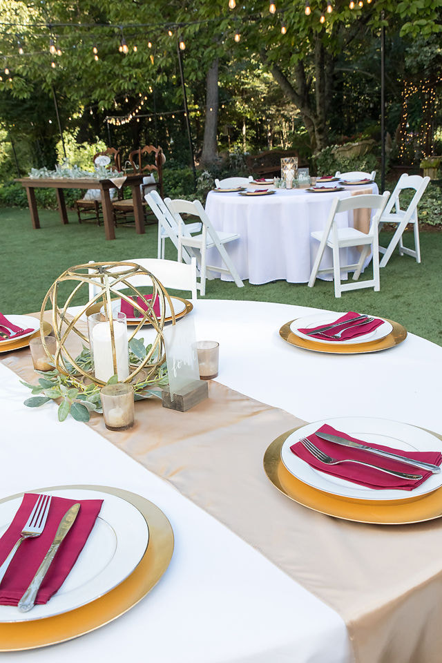 gold, champagne, and burgundy reception tables