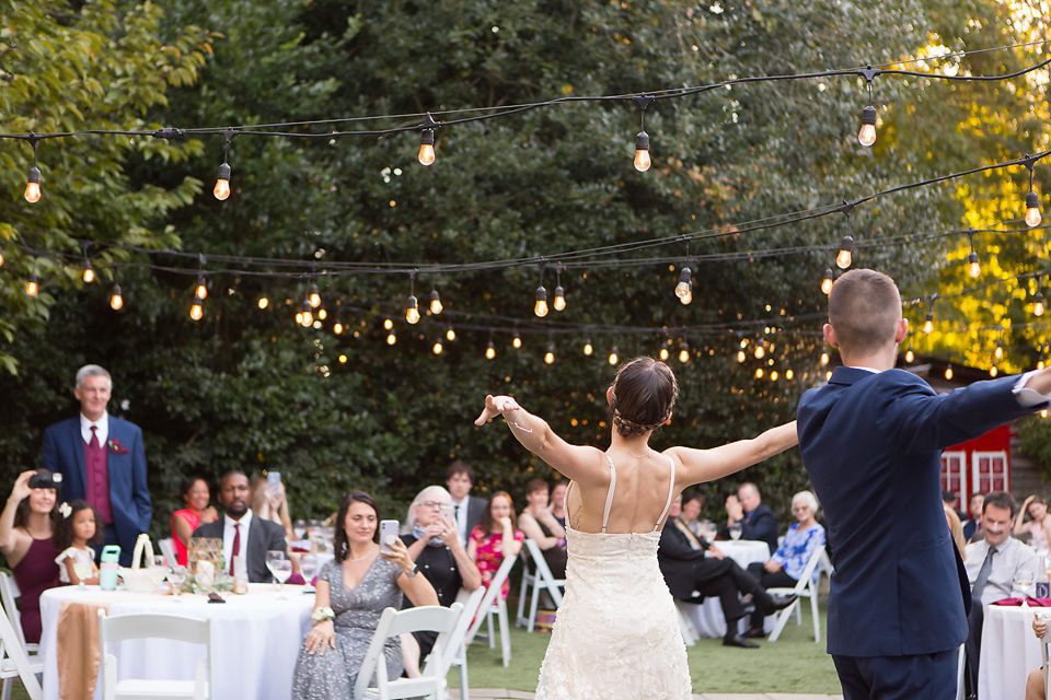 bride and groom performing waltz on outdoor dance floor