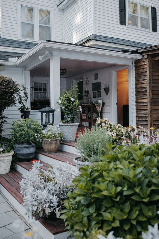 farmhouse back porch with potted plants