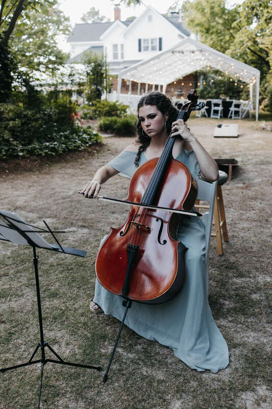 bridesmaid playing cello at outdoor ceremony