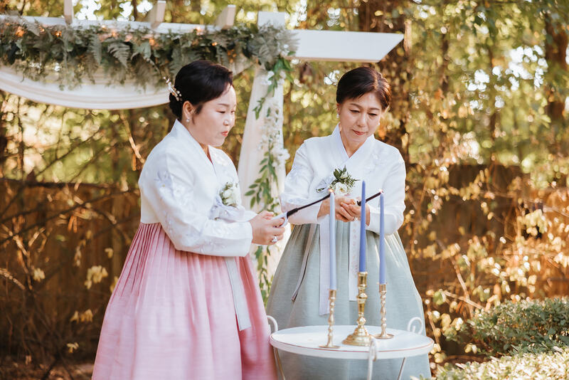 moms in korean hanbok lighting unity candles