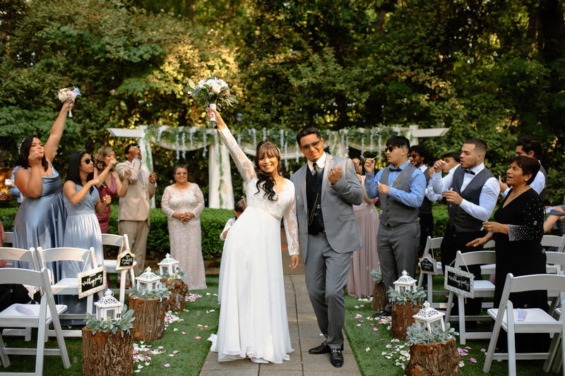 newlyweds posing in center of aisle during recessional