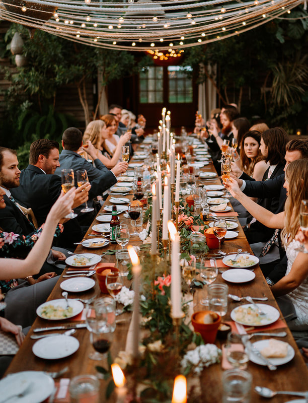 guests toasting with glasses at intimate reception dinner